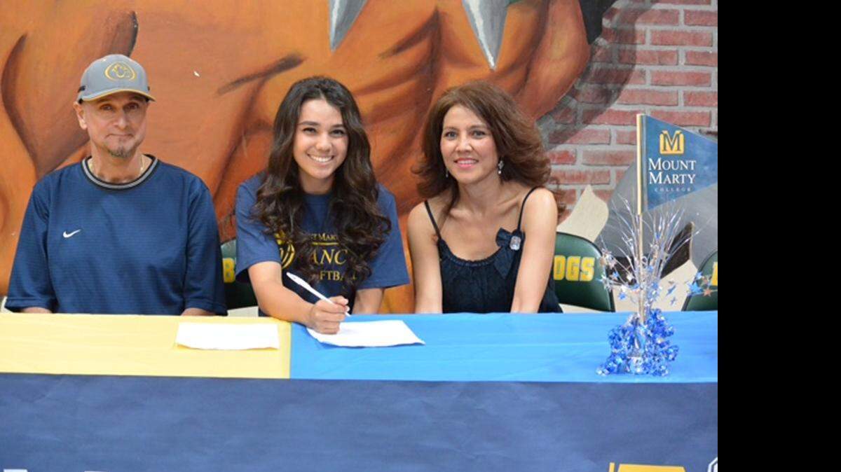 Le Grand High School pitcher Bianca Minor, accompanied by her parents, Louis and Sandy<137,2015/04/24,Bauman/c Paul - Sacramento1> Minor<137>, signs her letter of intent to attend Mount Marty College in Yankton, S.D.
