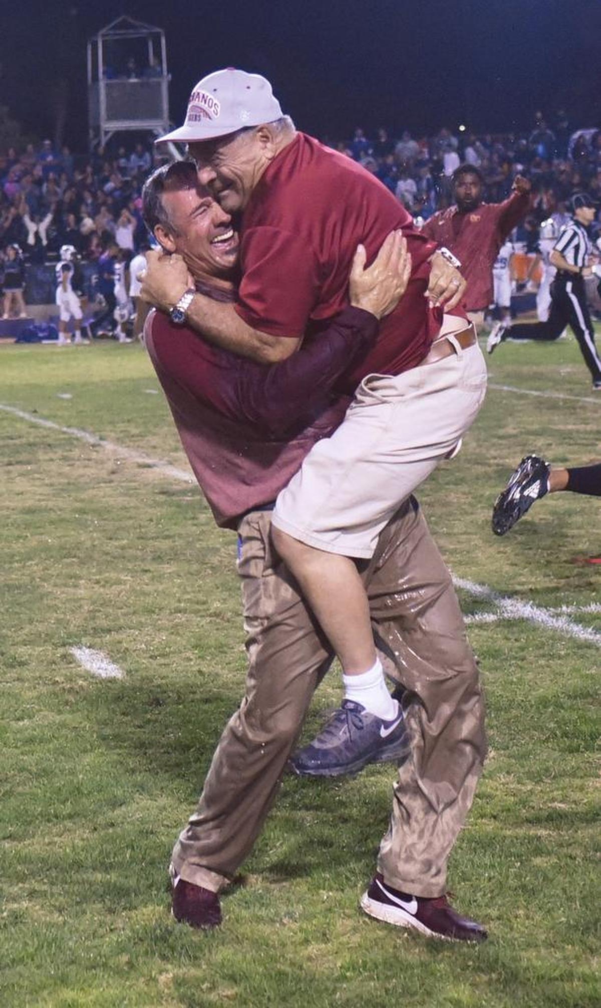 Los Banos Tiger head coach, Dustin Caropreso, left, hugs his father, Gary Caropreso after the Tiger 28-21 victory over the Pacheco Panthers Fri., Oct. 26, 2018 at Loftin Stadium in Los Banos.