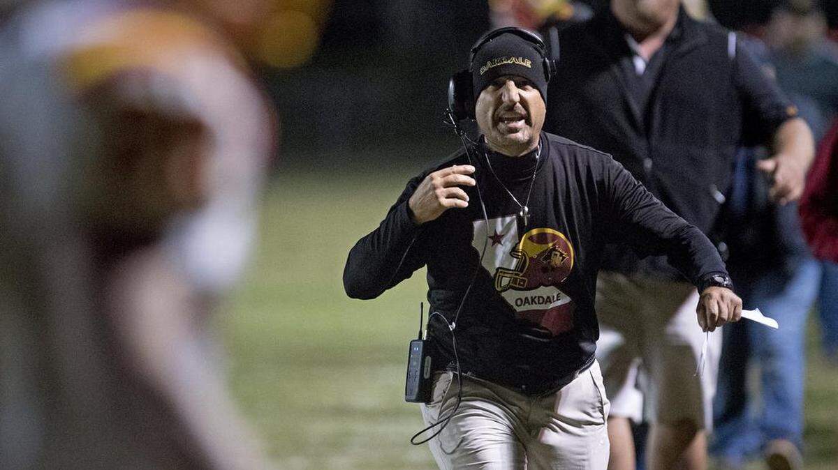 Oakdale coach Trent Merzon celebrates the go ahead touchdown over Central Catholic during the Valley Oak League game at Central Catholic High School in Modesto, Calif., on Friday, Nov. 3, 2017.