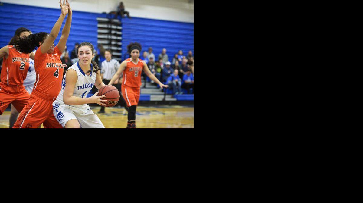 Atwater’s Heaven Mazon spins toward the basket as Merced’s Lexi Thompson defends at Atwater High School on Tuesday.