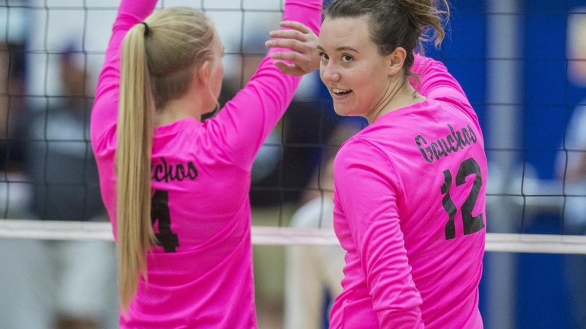 El Capitan senior MakenzieWebber (12) looks back to her teammate as the Gauchos prepare to serve during a match against Atwater at Atwater High School in Atwater, Calif., on Tuesday, Oct. 10, 2017.