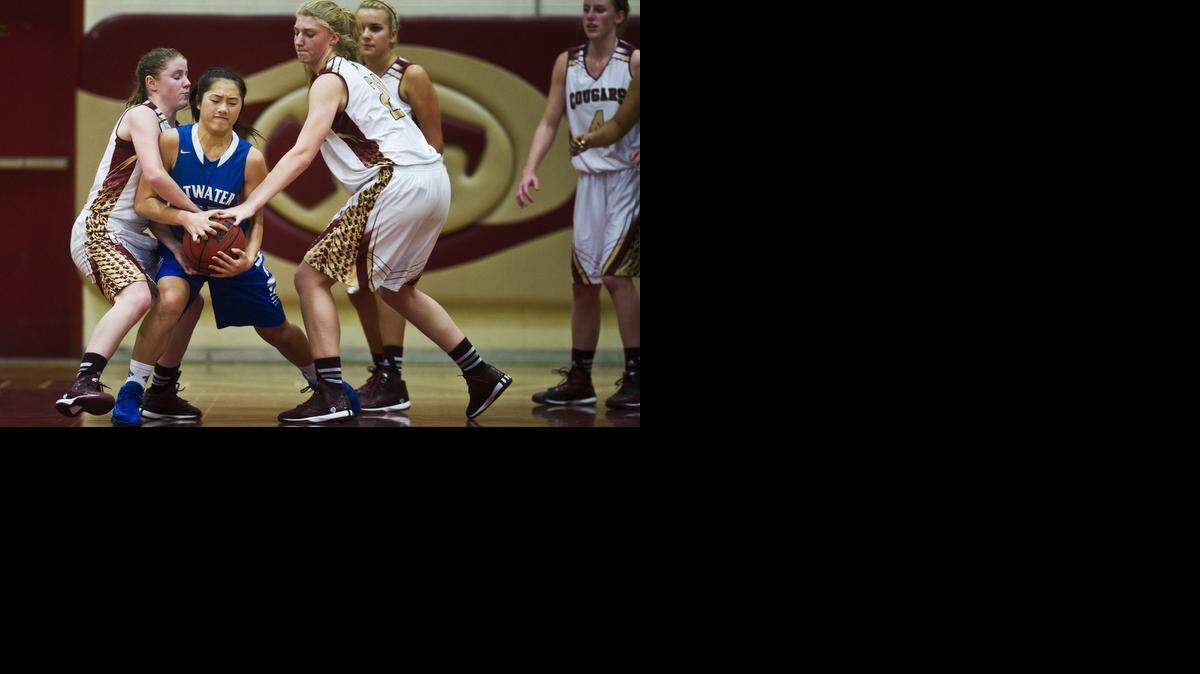 
Golden Valley freshman Delia Moore (3) and sophomore teammate Abbee Croninger (21) attempt to steal the ball from Atwater sophomore Jasmine Xiong (12) during a game at Golden Valley High School in Merced, Calif., Thursday, Jan. 15, 2015. The Cougars beat the Falcons 41-32.
