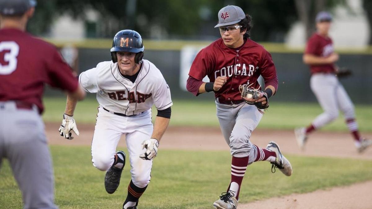 Golden Valley senior Jiovany Landeros (2) runs down and tags out Merced senior Tanner Pellissier (8) during the 14th annual Nannini game at Merced High School in Merced, Calif., on Friday, May 5, 2017. The Cougars beat the Bears 14-2.