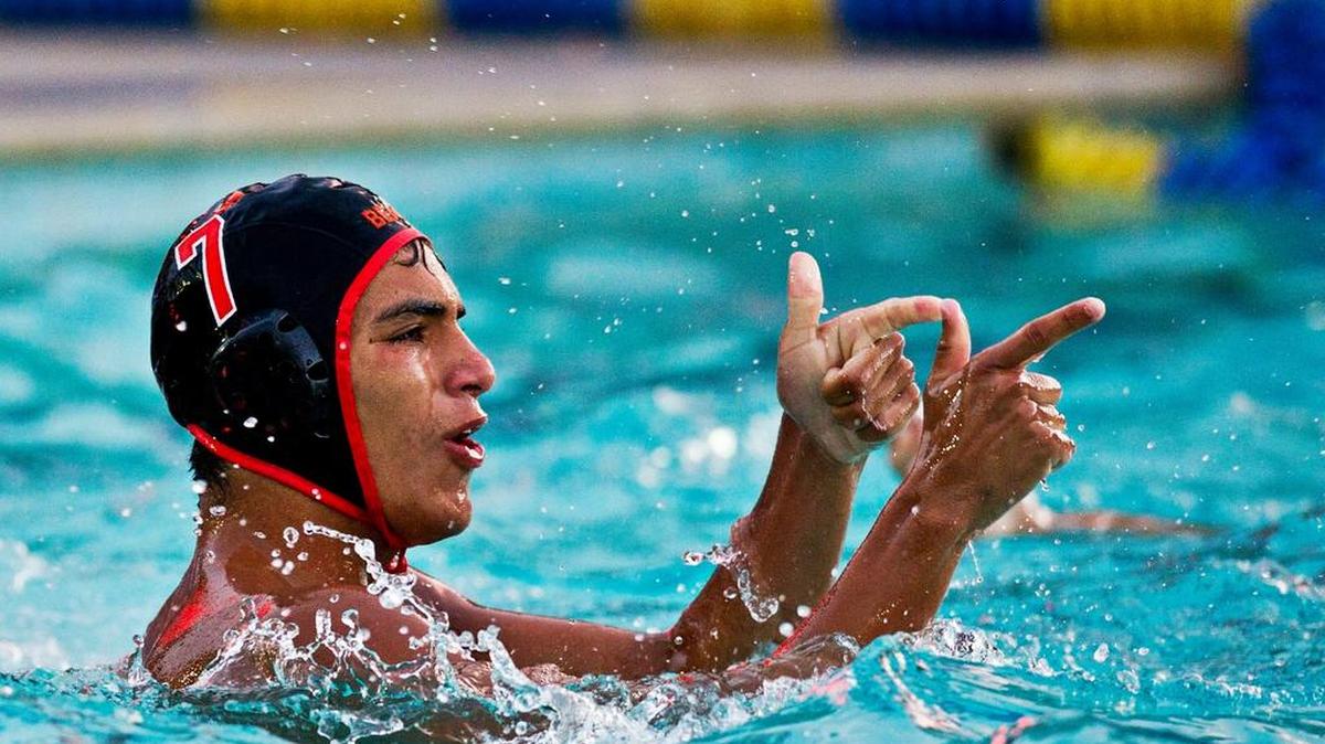 
Merced’s Abraham Santana points to the crowd after scoring a goal during a water polo match against Atwater at Merced High School last season. 
