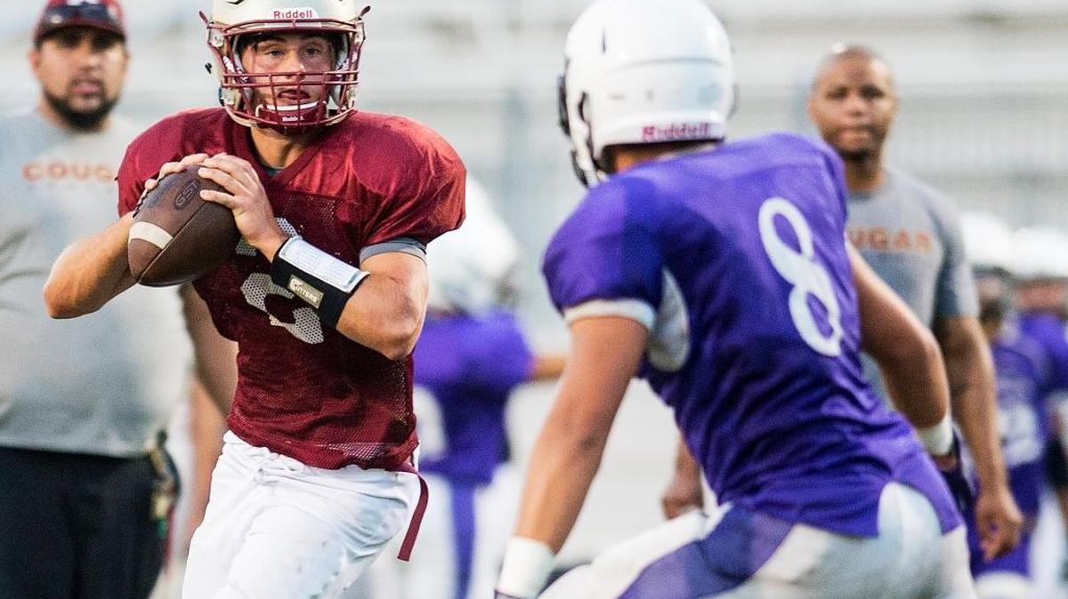 Golden Valley quarterback Jack Sollis (2) scrambles out of the pocket during a scrimmage at Golden Valley High School in Merced, Calif., on Saturday, Aug. 19, 2017. The Couagars opened with a 37-0 loss to Gregori.