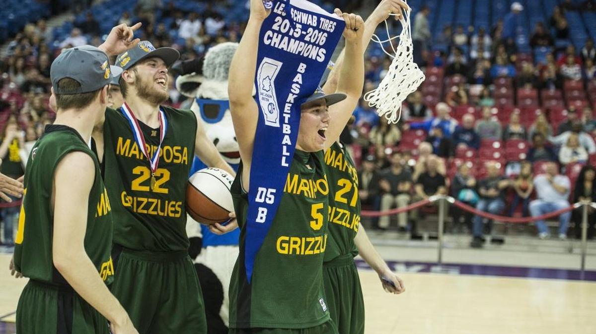 Mariposa senior Bradley Chambers (5) carries the division championship pennant after defeating the Brookside Christian Knights 79-75 in the Sac-Joaquin Section Division V Championship game at Sleep Train Arena in Sacramento, Calif., Friday, March 4, 2016.