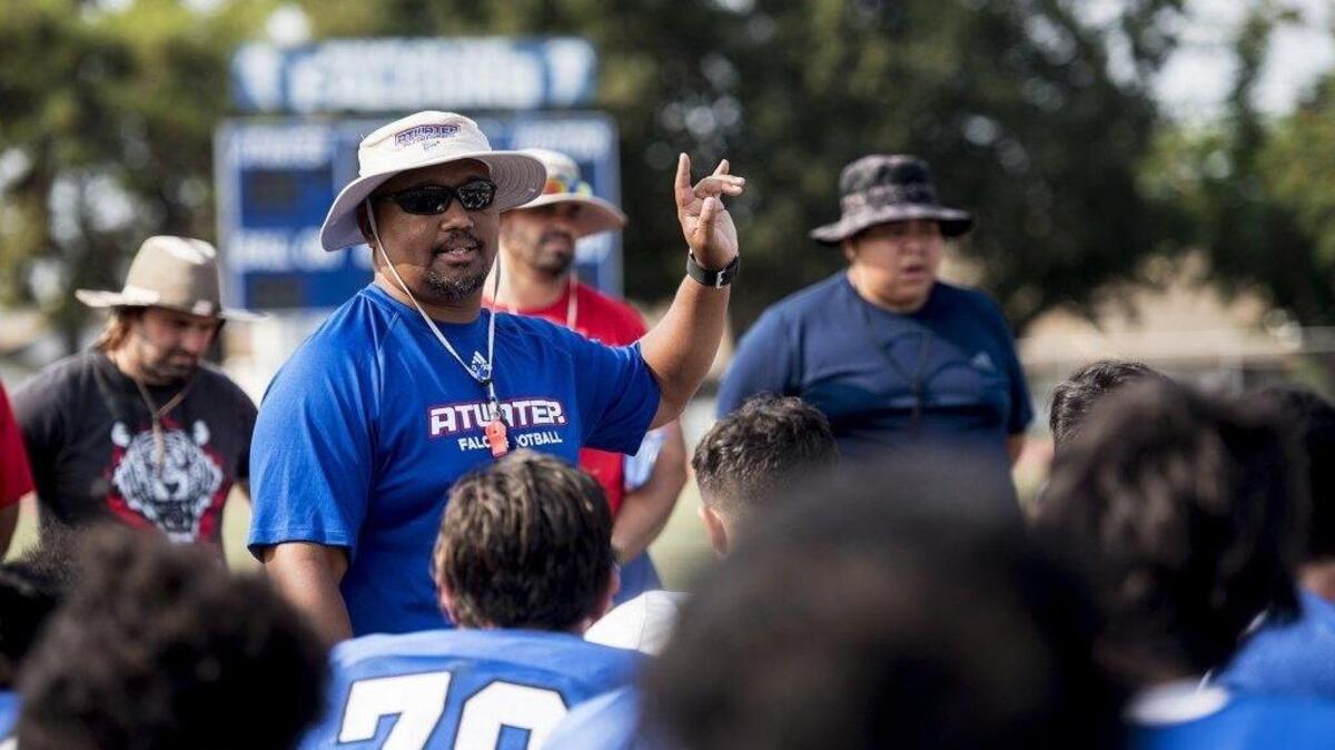 Atwater head coach Seneca Ybarra speaks to players during football practice at Atwater High School in Atwater, Calif., on Tuesday, July 31, 2018.