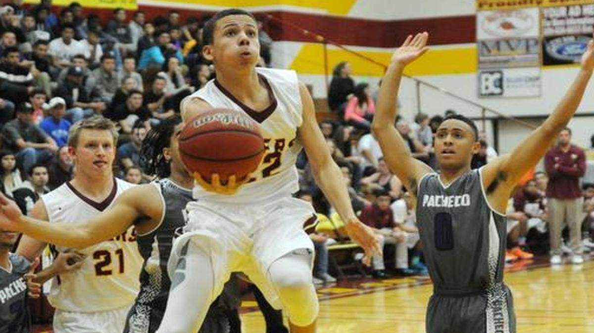 Los Banos’ Brevin Welch maneuvers through traffic for a basket in the first quarter of a cross-town clash Friday night against Pacheco.