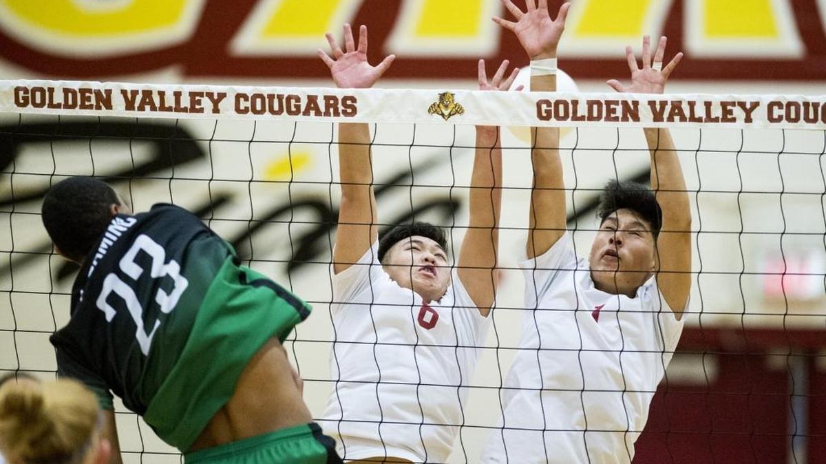 Golden Valley junior junior Toukue Her (8) and senior Jim Chang (7) attempt to block a spike by El Camino sophomore Freddy Batiratu (23) during a Sac-Joaquin Section Division II playoff match at Golden Valley High School in Merced, Calif., on Thursday, May 11, 2017. The Eagles beat the Cougars 3-1.