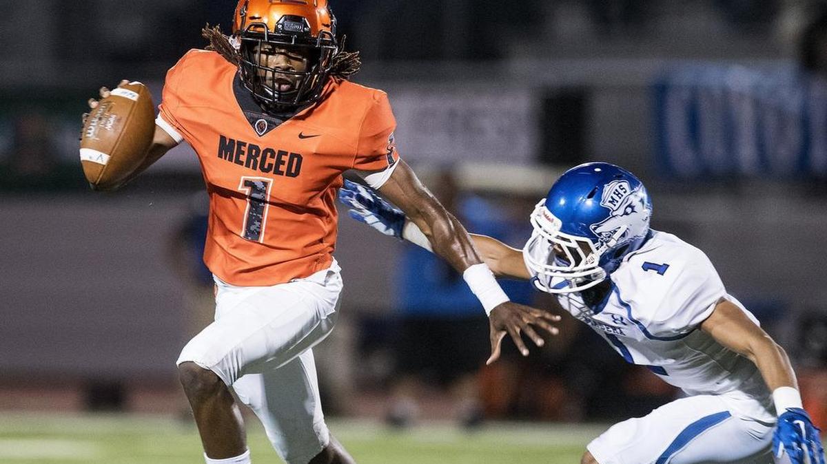Merced senior quarterback Dhameer Warren (1) scrambles out of the pocket during a game against Madera at Veterans Stadium on the campus of Golden Valley High School in Merced, Calif., on Friday, Sept. 7, 2018. The Bears beat the Coyotes 63-35.