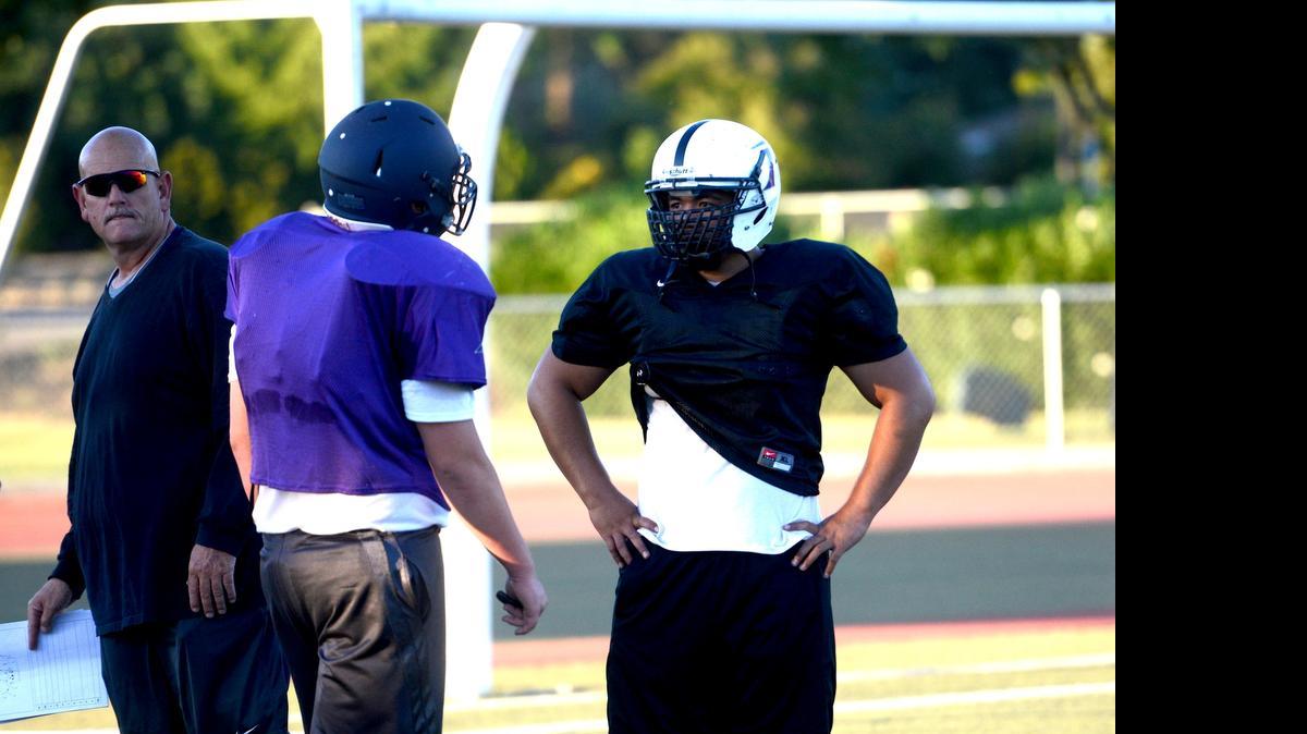 
Pacheco’s Josh Tui, right, chats with one of his North teammates in between drills at practice on Monday. Tui will represent the North in the 30th annual North/South Rotary All-Star Football Game. Monday, June 23, 2015.
