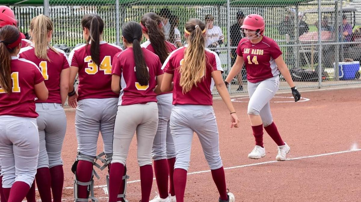 Los Banos freshman Cassandra Augustine (14) is greeted by her teammates at the plate after Augustine drilled a two-run home run in the second inning. Tuesday, May 16, 2017.