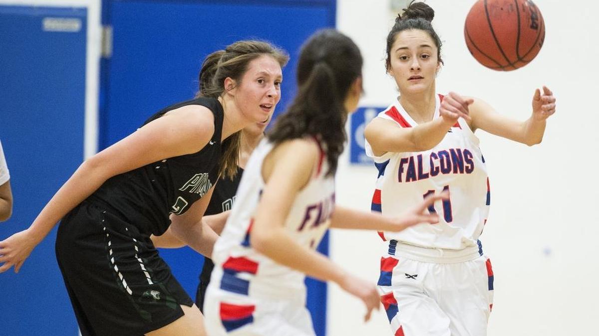 Atwater’s Lexi Valencia (11) passes to twin sister Kelsey Valencia (1) during a game against Pitman at Atwater High School last season. Lexi Valencia injured her elbow during a game on Tuesday night against Pitman.