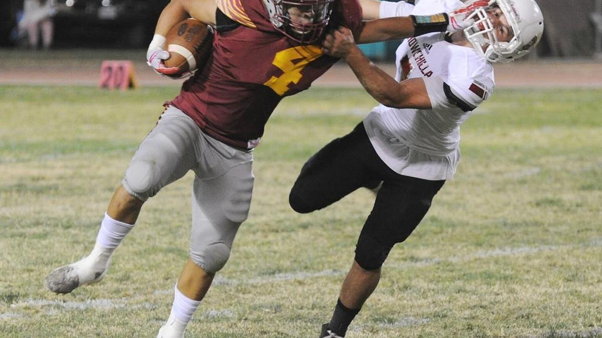 Los Banos High School running back, Antonio Lopez, left, stiff arms Chowchilla linebacker, Cody Woolsey in the second quarter Fri., Sept. 29, 2017 at Loftin Stadium in Los Banos.