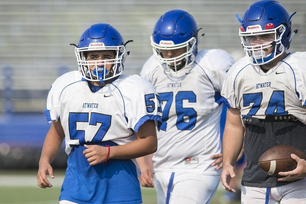 Atwater’s Rafael Gomez, left, walks off the field during football practice at Atwater High School in Atwater, Calif., on Tuesday, July 31, 2018.