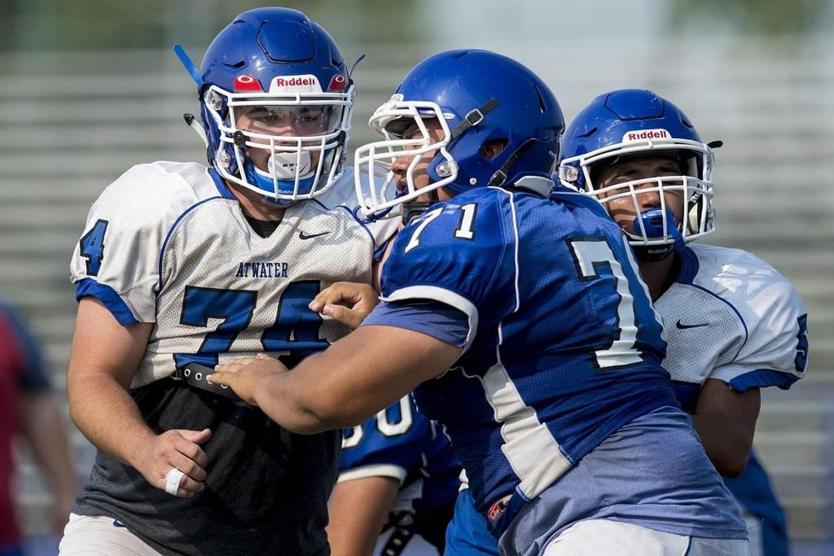 Atwater’s Kaden Ramirez, left, blocks during football practice at Atwater High School in Atwater, Calif., on Tuesday, July 31, 2018.