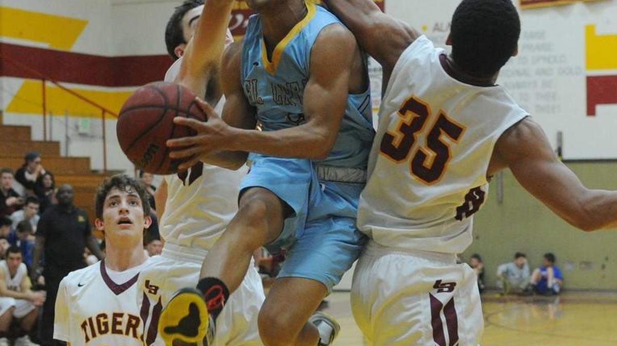 El Capitan’s Isaiah Knott, middle, splits a pair of Los Banos defenders on Tuesday night. Knight had a game-high 17 points in the Gauchos’ victory.