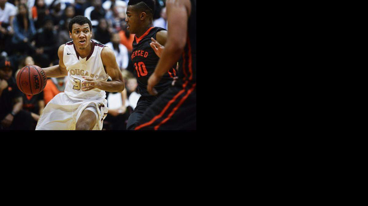 
Golden Valley High senior Lee McNeill gets around Merced junior Alexander Ray Stewart en route to 26 points on Friday.
