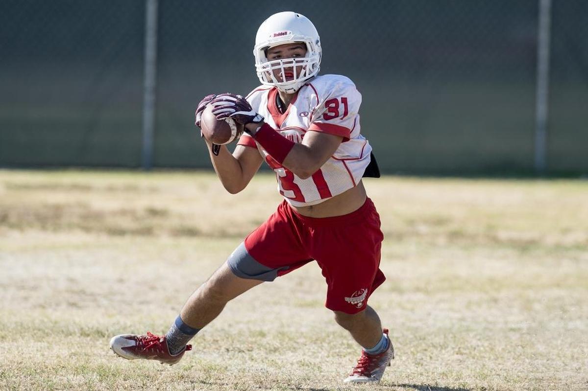 Chowchilla’s Luciano Manzo catches a pass during football practice at Chowchilla High School in Chowchilla, Calif., on Thursday, Aug. 2, 2018.