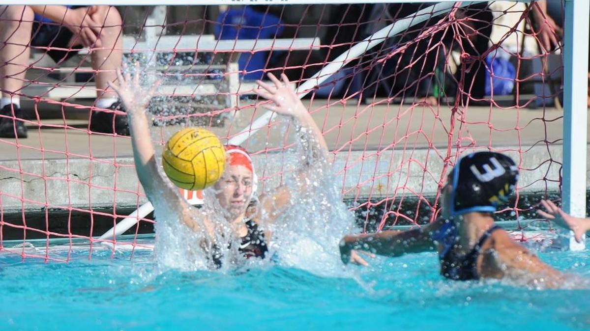 BEA AHBECK/NEWS-SENTINEL Lodi's goalie Aslee Cooley defends as El Capitan's Madison Nolen shoots during their section semifinals game in Lodi Wednesday, Nov. 9, 2016.