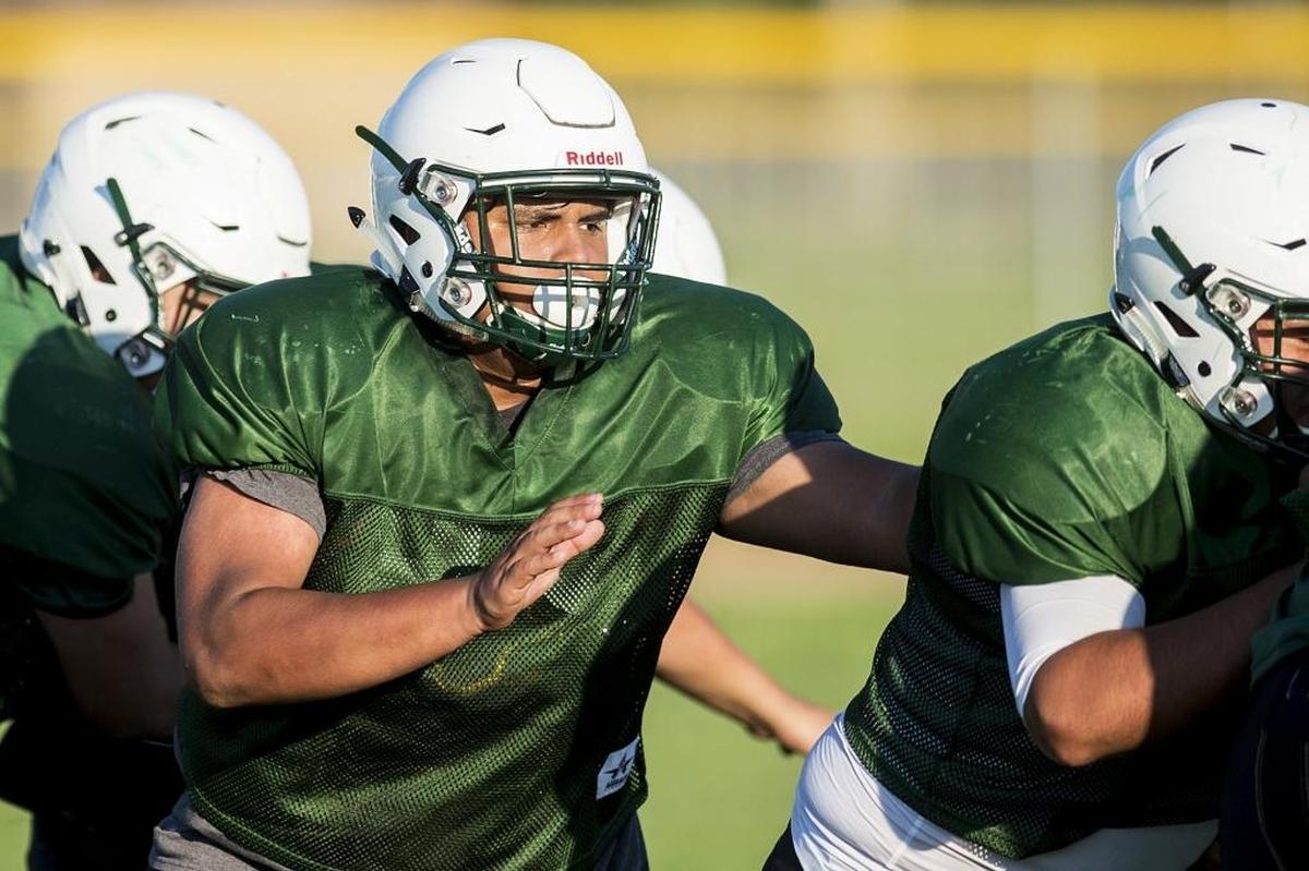 Le Grand’s Antonio Puente blocks during football practice at Le Grand High School in Le Grand, Calif., on Thursday, Aug. 2, 2018.