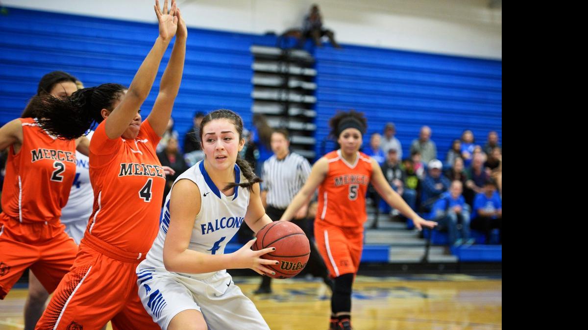 
Atwater junior Heaven Mazon (right) spins toward the basket against Merced junior during a game in January.
