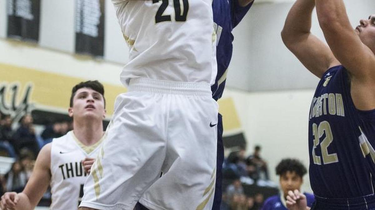 Buhach Colony junior Chris Portillo (20) fights for a rebound during a game against Livingston at Buhach Colony High School in Atwater, Calif., on Thursday, Dec. 8, 2016. The Thunder beat the Wolves 74-71.