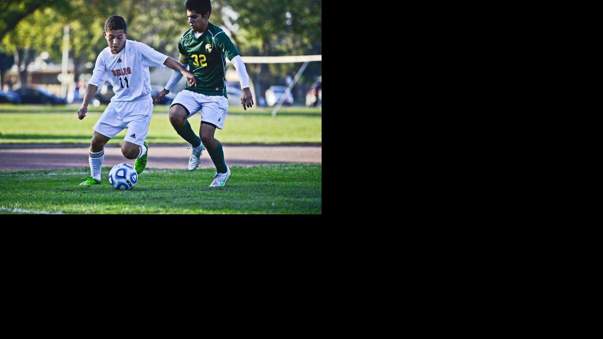 
Merced junior Willmer Pena (11) gets around Tracy's Jonny Marin (32) during a game at Merced High School in Merced, Calif., Tuesday, Nov. 4, 2014. The Bears beat the Bulldogs 3-1.

