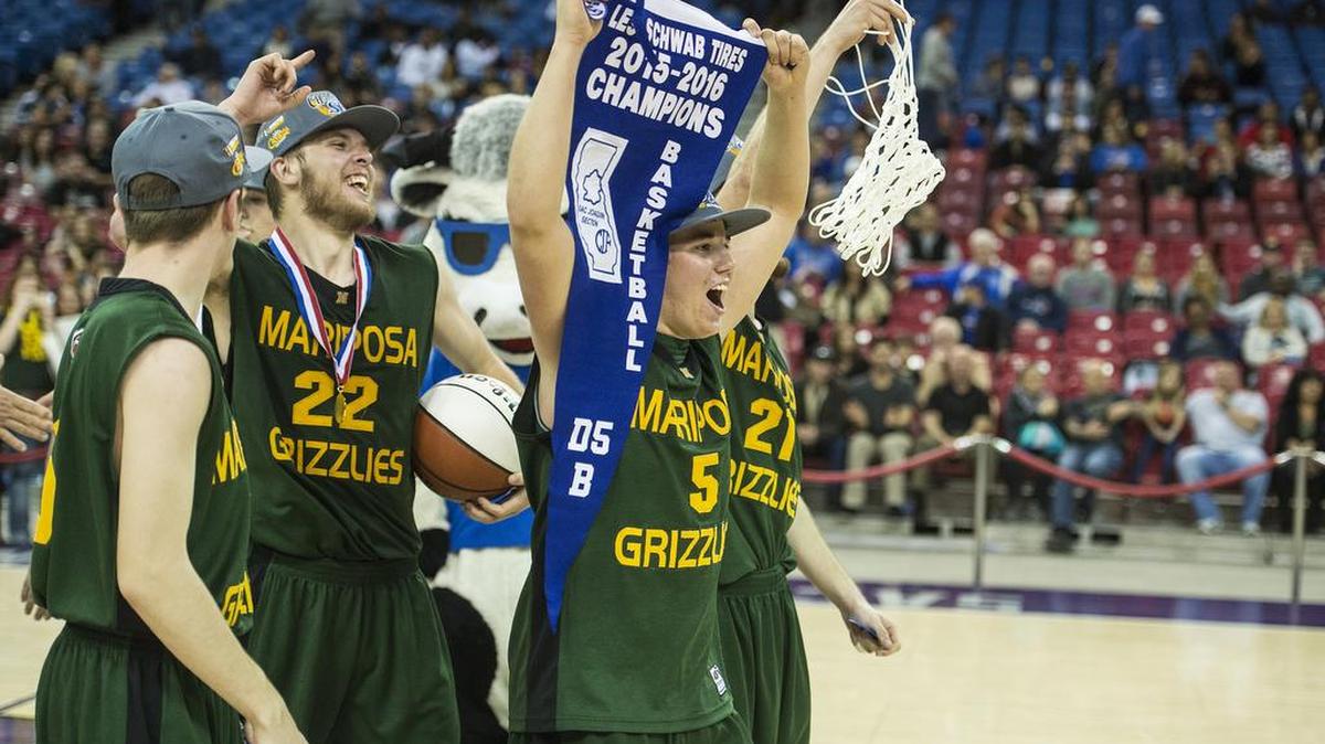Mariposa senior Bradley Chambers (5) carries the division championship pennant after defeating the Brookside Christian Knights 79-75 in the Sac-Joaquin Section Division V Championship game at Sleep Train Arena in Sacramento, Calif., Friday, March 4, 2016.