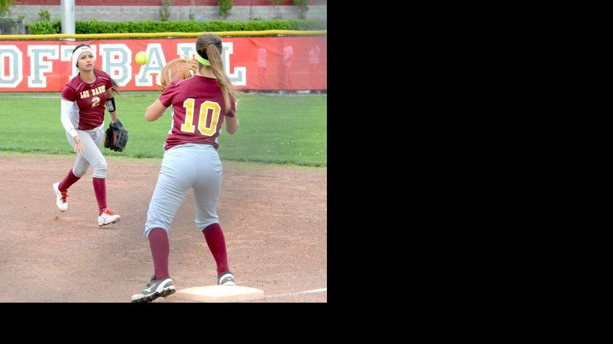 
Los Banos second baseman Hailey Quintana (2) flips the ball to first baseman Kylee Cardoza for an out in Tuesday's 6-4 win over Ceres.
