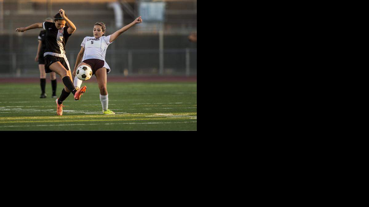 
Golden Valley sophomore Megan Pust (5) and Merced sophomore Elizabeth Mendoza (13) battle for the ball during a game at Golden Valley High School in Merced, Calif., Tuesday, April 14, 2015.
