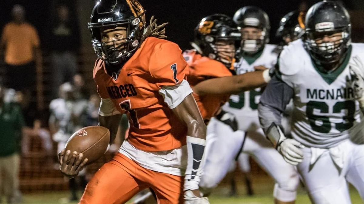 Merced High quarterback Dhameer Warren runs the ball against McNair during the Bears' 41-27 victory at Merced High School on Sept. 8, 2017.