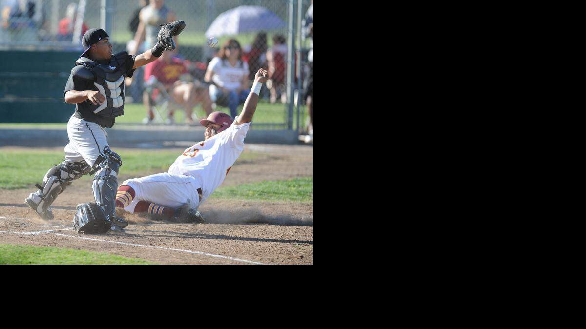 
Pacheco High School catcher Ricky Lopez can't tag Los Banos' Chris Corral in time Wed., March 18, 2015 at Los Banos High School.
