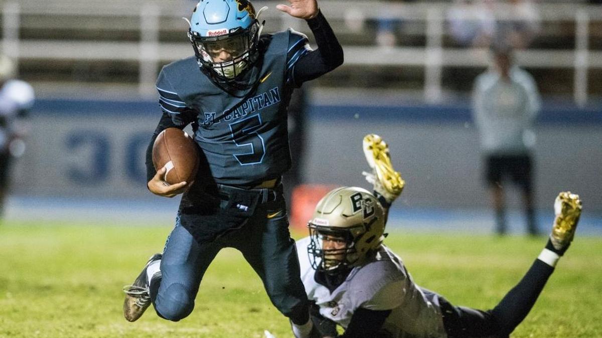 El Capitan junior quarterback Kevin Reid (5) is tripped up by Buhach Colony senior Irik Dobbins (44) during a game at Stadium '76 in Merced, Calif., on Friday, Oct. 6, 2017. The Thunder beat the Gauchos 60-13.