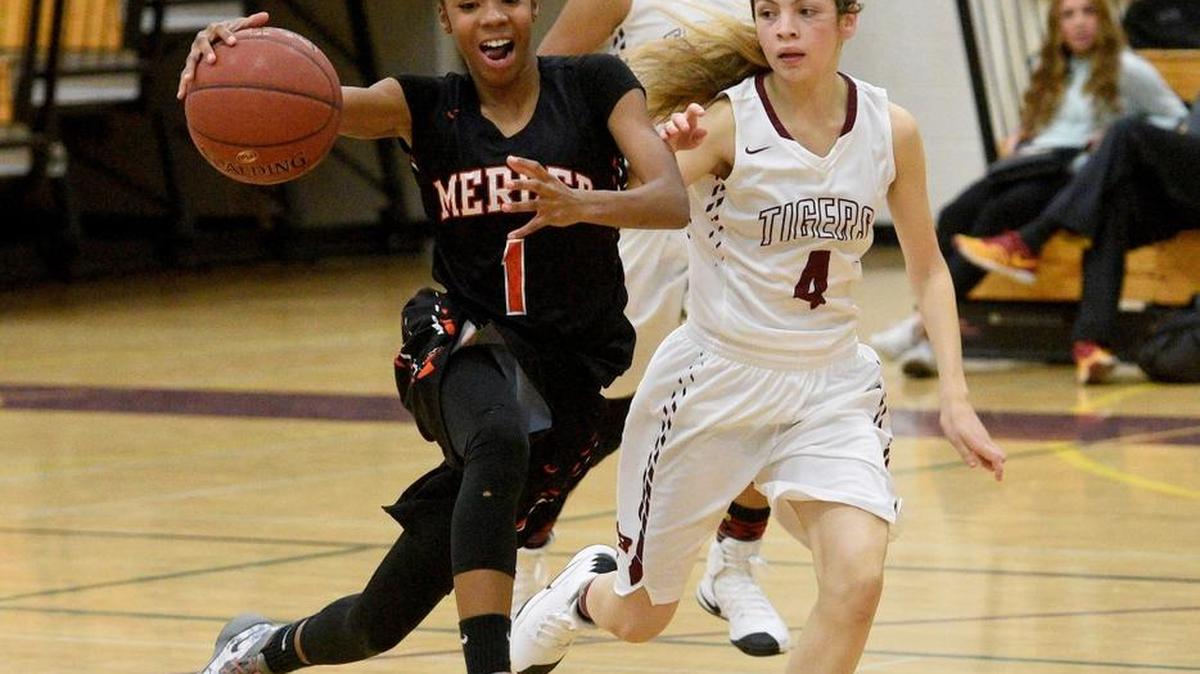 Merced's Amaya Ervin (1) drives the lane while Los Banos' Monica Nino attempts to defend. Monday, Dec. 12, 2016 in Los Banos.
