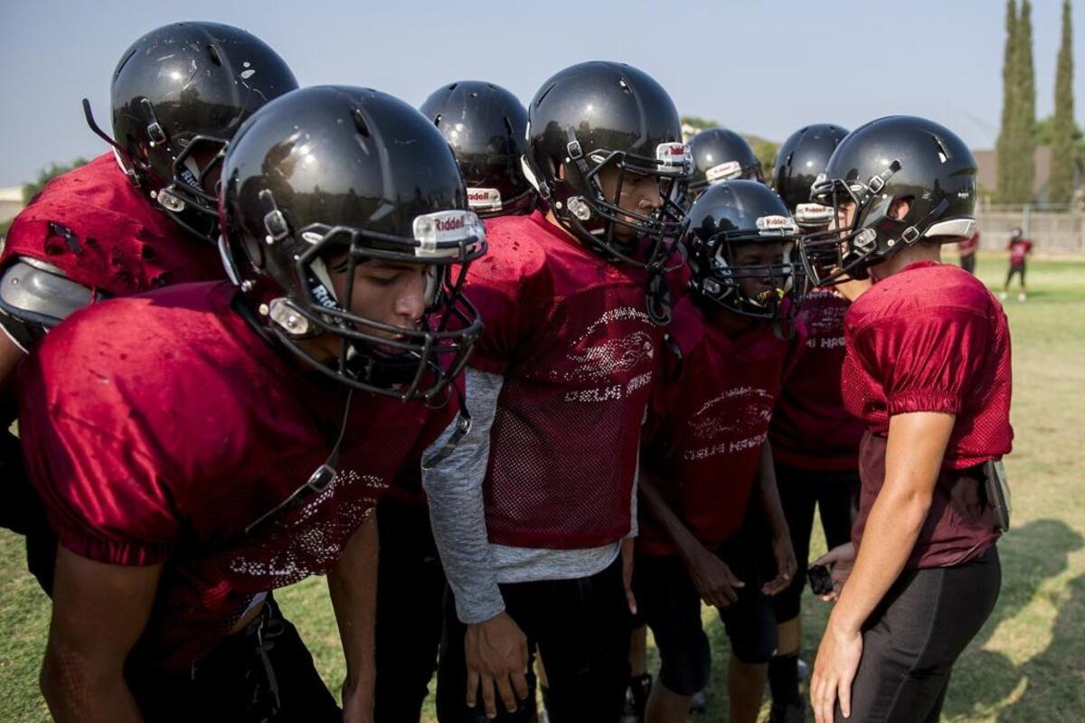 Delhi varsity players huddle up during football practice at Delhi High School in Delhi, Calif., on Thursday, Aug. 9, 2018.