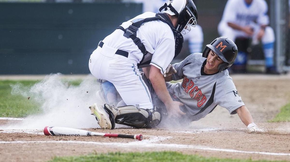 El Capitan senior catcher Dustyn Greggains (4) tags out a Merced baserunner at home plate during a game at El Capitan High School in Merced on Thursday, March 3, 2016. The Bears beat the Gauchos 10-4 after the game was called in the seventh inning due to darkness.