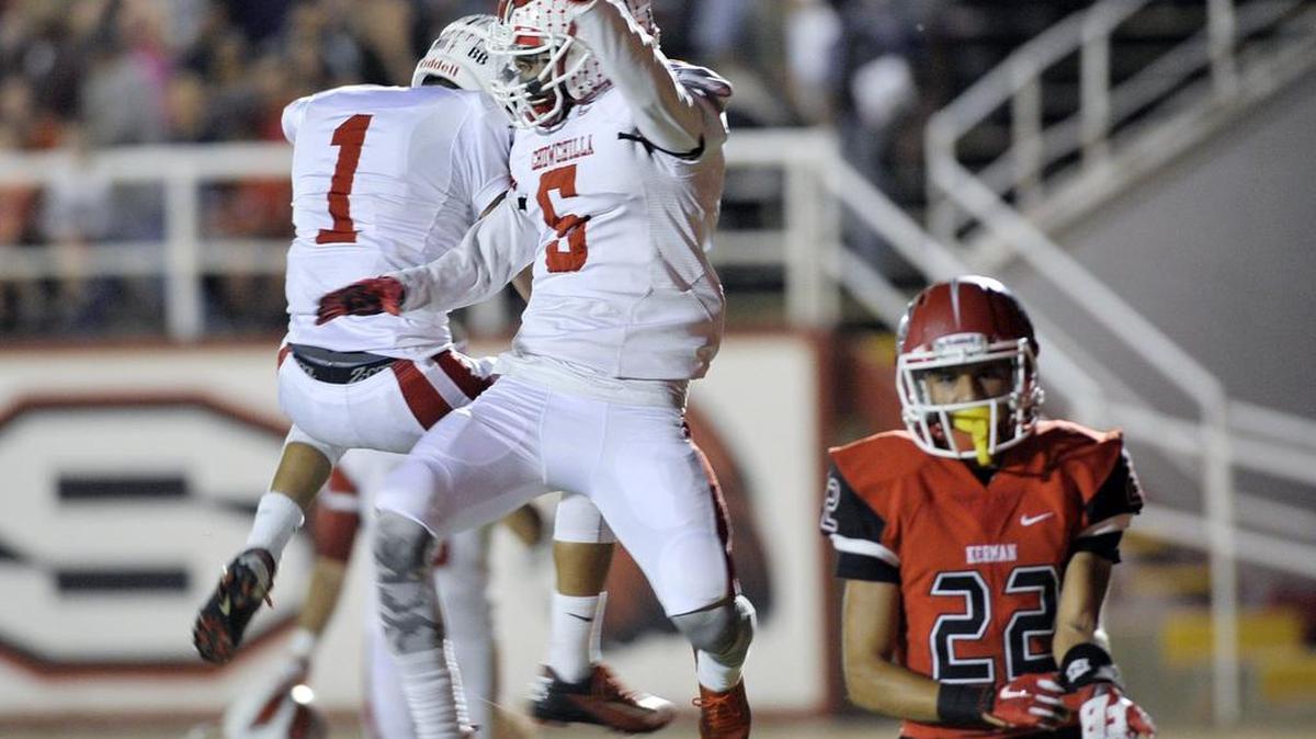Chowchilla’s Bernardo Bustillos, left, celebrates Chowchilla’s Anthony Stewart’s touchdown with Stewart, center, in the first quarter while Kerman’s Angel Lechuga, right, walks away on Oct. 9, 2015, in Kerman.