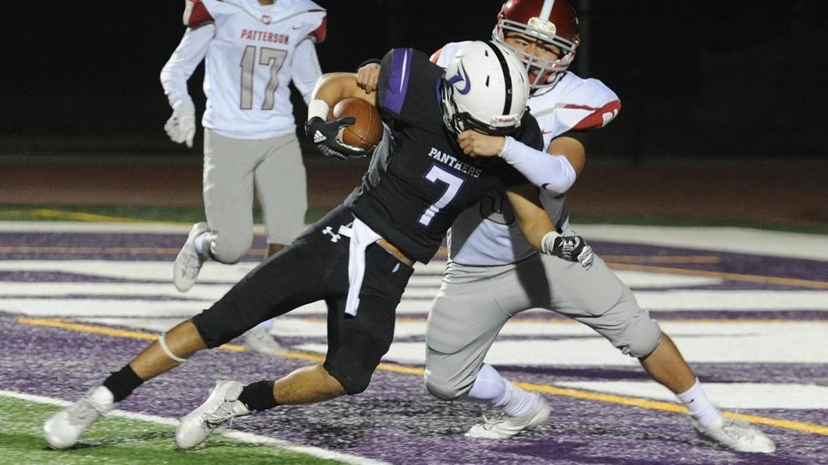 Pacheco High wide receiver, Jacob Levario forces his way into the endzone to score a touchdown in the fourth quarter against linebacker, Paul Mendoza iFri., Oct. 6, 2017 in Veterans Stadium in Los Banos.