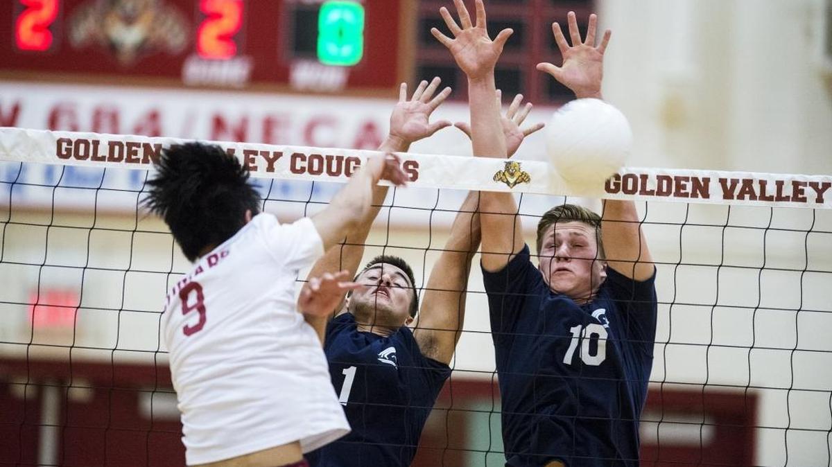 Stone Ridge Christian juniors Nelson Machado (1) and Bryce Louters (10) attempt to block the spike of Golden Valley senior Cha Moua (9) during a match at Golden Valley High School in Merced, Calif., on Tuesday, April 11, 2017. The Cougars beat the Knights 3-0.