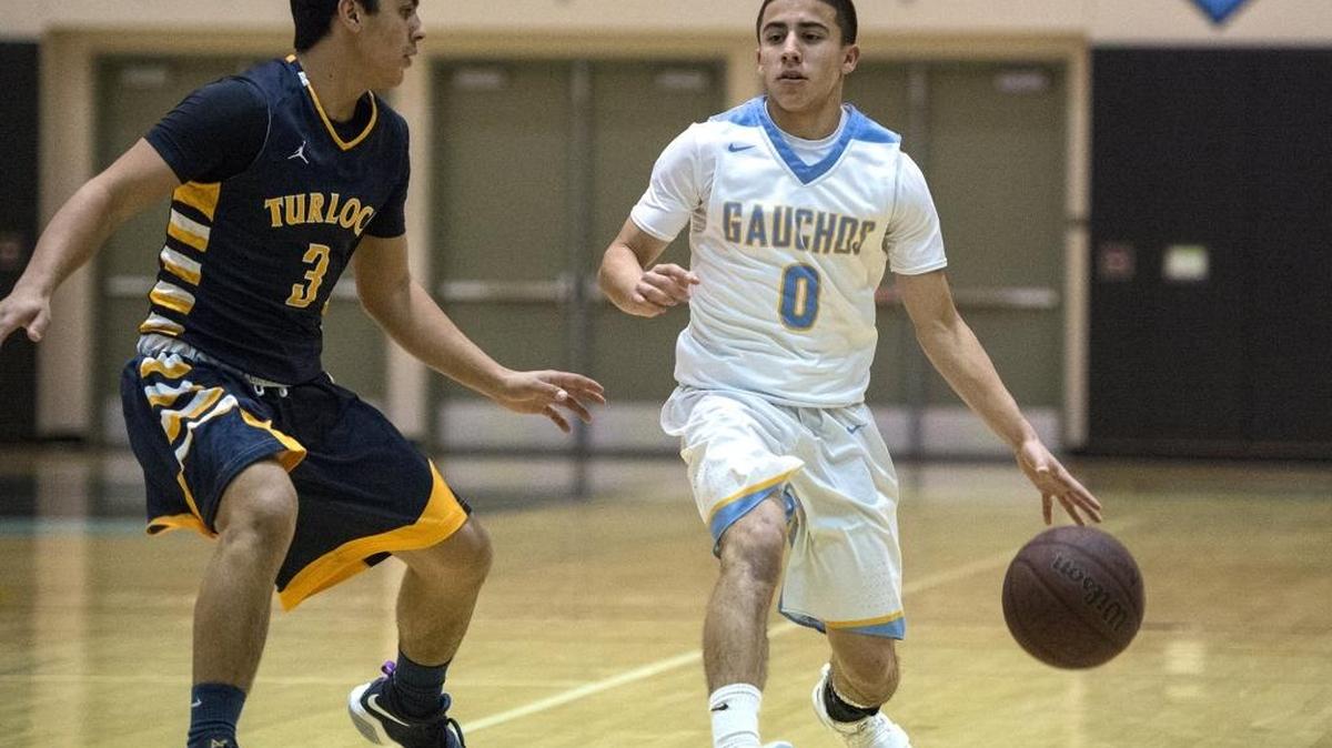 El Capitan senior Angel Serena (0) attempts to get past Turlock senior Arik Bains (3) during a game at El Capitan High School in Merced, Calif., on Wednesday, Jan. 3, 2018. The Gauchos beat the Bulldogs 63-40.