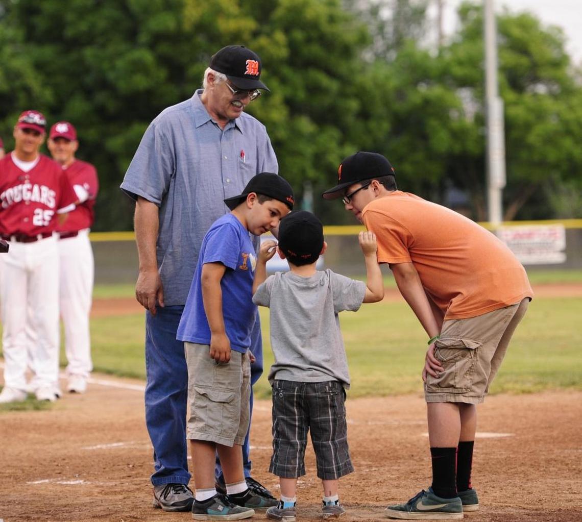 Dave Nannini holds the mike as his grandsons Brevin, 9, Ty, 4, and Andrew, 12, (all Nannini) say ‘Let’s play ball’ before the Nannini Baseball Game in Merced Friday. (4-11-14)