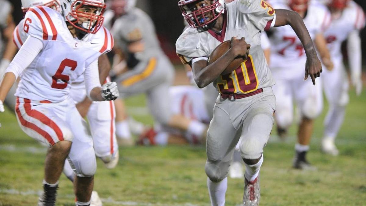 Los Banos running back Kris Kyles, right, runs away from Ceres defender Israel Oregel on Friday in the third quarter in Los Banos. Los Banos won the game 42-7.