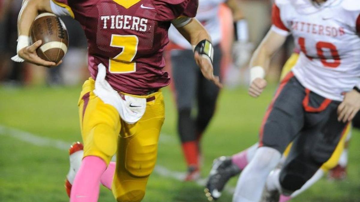 
Los Banos quarterback Adam Herrera looks for running room against Patterson on Friday night at Loftin Stadium.
