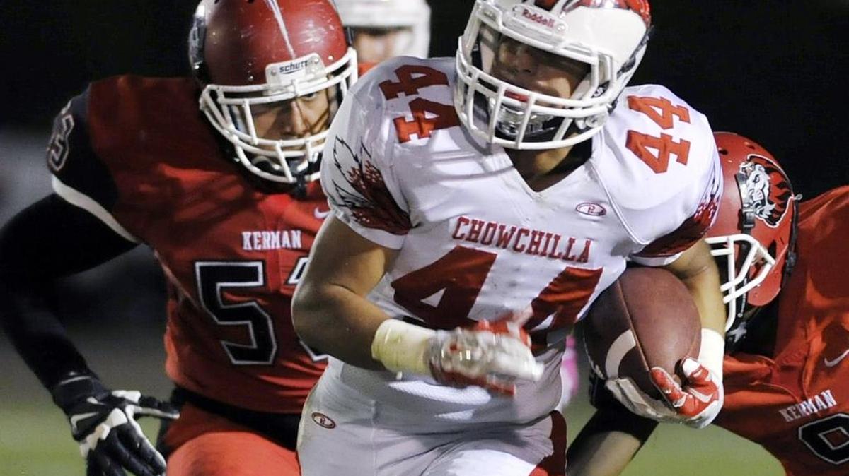 Chowchilla’s Alex Gutierrez runs through a hole in the Kerman defense on Oct. 9.