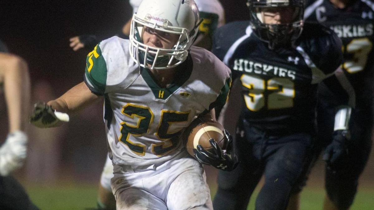 Hilmar running back Cody Rentfro sprints through the defense during a game between Hilmar High School and Hughson High School, where Hilmar won in overtime 43-42, at Hughson High School in Hughson California on October 23, 2015.