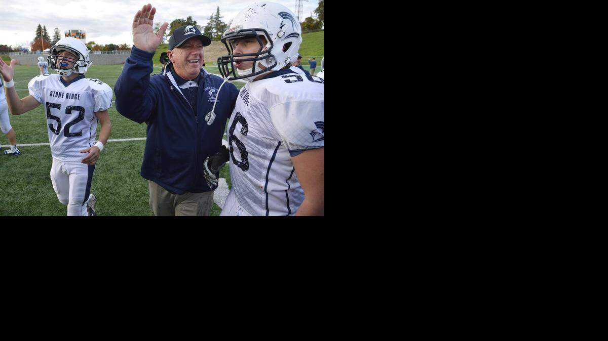 
Stone Ridge Christian coach Arthur DeJager , players, Gabriel Bartholemew (52) and Luke Jenkins (56) celebrate their 19-14 victory over Elliot Christian in the CIF Sac-Joaquin Section Division VII championship game in Lodi, Calif., on Saturday, November. 29, 2014.
