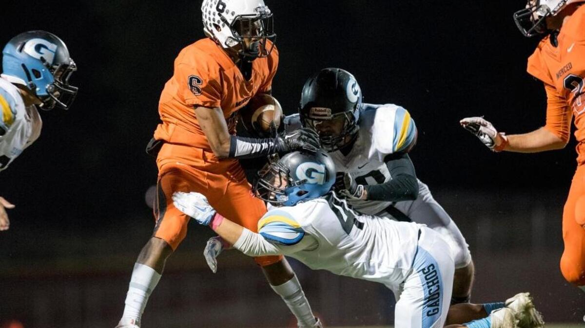 Merced senior running back Paul Scoggins is stopped by the El Capitan defense during a game at Veterans Stadium on the campus of Golden Valley High School in Merced, Calif., Friday, Oct. 14, 2016. The Bears beat the Gauchos 47-7.