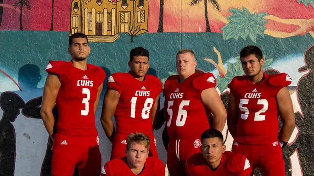 Chowchilla High School football players top row from left, Moayad Dahabra (3), Ronnie Reyes (18), Dylan Rees (56), Gabriel Sanchez (52), Damon Perry (23), and Bernardo Bustillos (1) pose for a photo at Chowchilla High School in Chowchilla, Calif., Tuesday, Aug. 16, 2016.