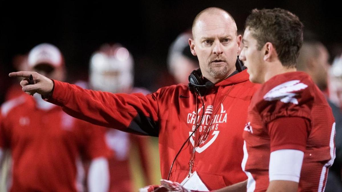 Chowchilla head coach Alex Pittz speaks with sophomore running back Justin Cantrell (8) during the Central Section Division IV Semifinal game against Kerman at Chowchilla High School in Chowchilla, Calif., Friday, Nov. 27, 2015. The Redskins beat the Lions 46-27.